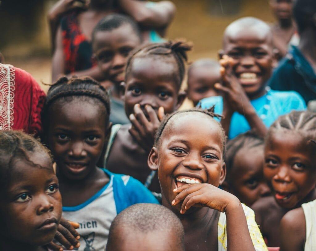 Smiling children expressing joy and hope in the humanitarian consulting community